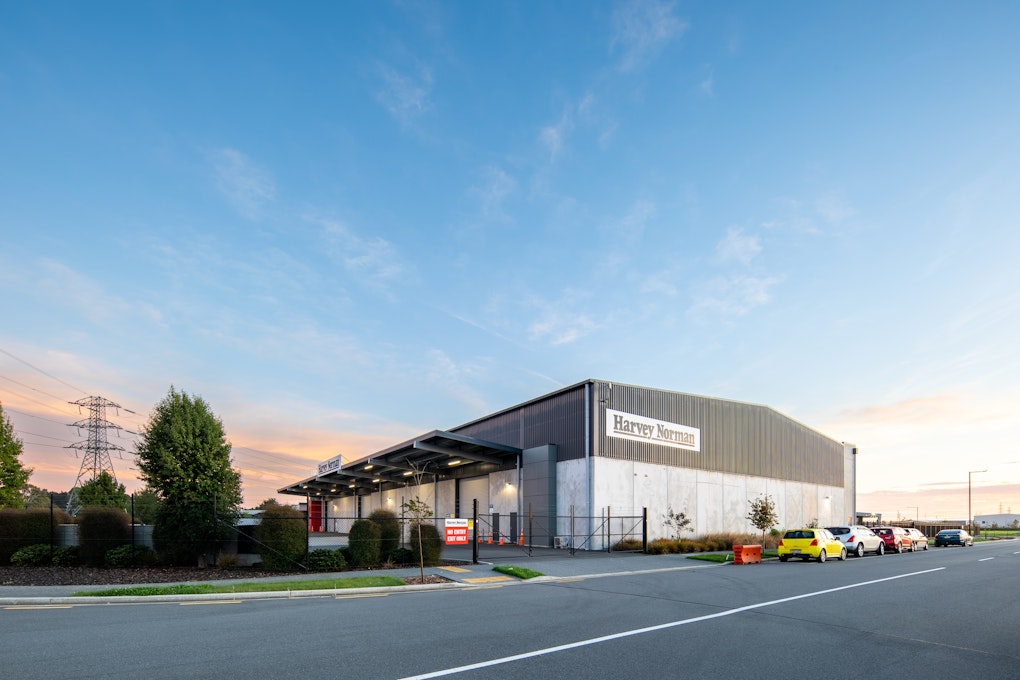 Harvey Norman distribution centre is proudly set against a blue sky with sunset at the rear.